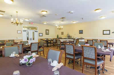 Dining room with tables set for residents