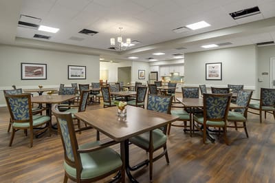 Bright common area with dining tables and chairs