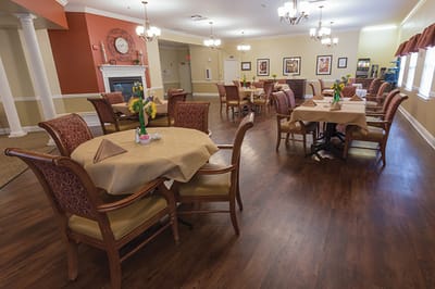 Dining room set up for residents with tables and chairs