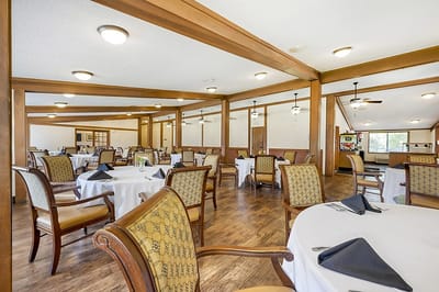 Dining area with tables and chairs set for meals