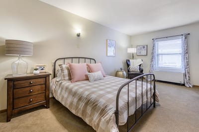 Cozy bedroom setup with a bed and armchair
