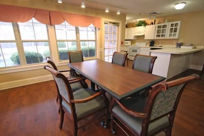 Common area with a large wooden table and chairs