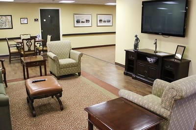 Bright common area with seating and TV