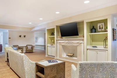 Bright common area with comfortable seating and a fireplace
