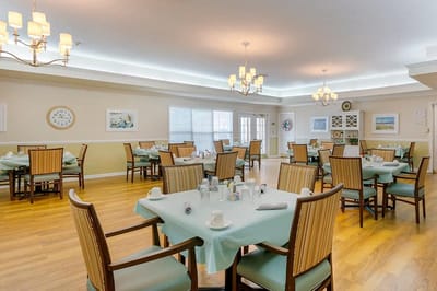 Dining area with tables and chairs set for meals