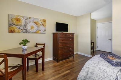 Cozy resident room with a bed and dining table