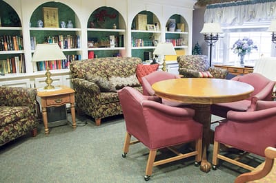 Comfortable common area with seating and bookshelves
