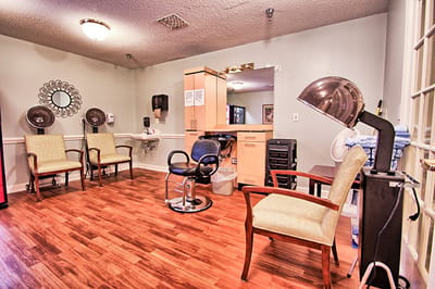 Hair salon area with chairs and styling station