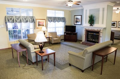 Bright common area with seating and fireplace