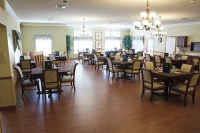 Dining room with tables and chairs set up for meals