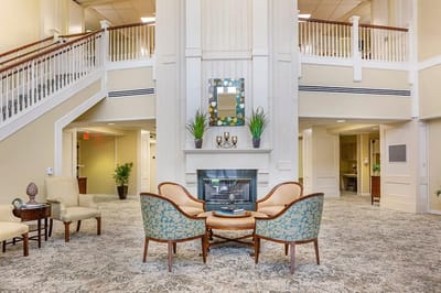 Bright interior common area with seating and a fireplace