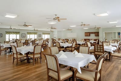 Bright dining room with tables set for meals