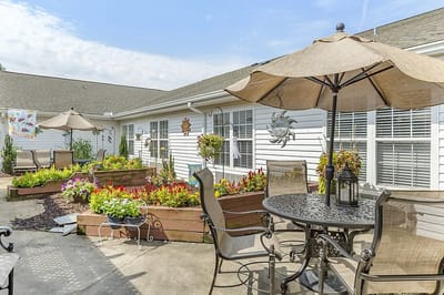 Sunny outdoor patio with flowers and seating