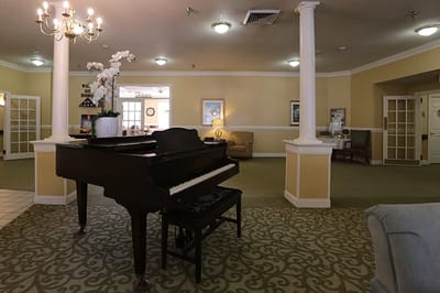 Interior view of a lounge area with a piano and seating