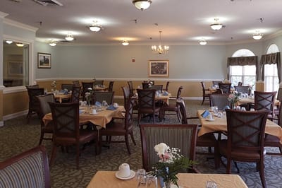 Dining area with beautifully set tables and flowers