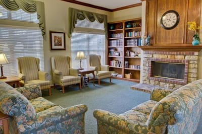 Cozy lounge area with seating and bookshelf
