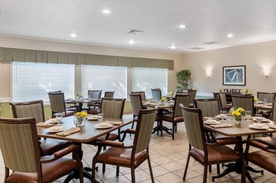 Dining area set up with tables and flowers