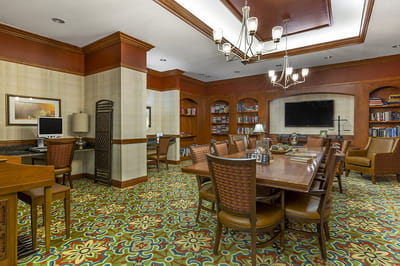 Interior view of a common area with tables and bookshelves