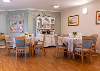 Interior dining room setup with tables and decorations