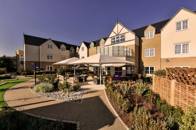 Outdoor seating area at Bucklesham Grange with landscaped gardens