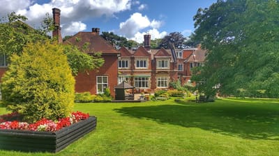 Exterior view of Burnham Lodge with landscaped garden