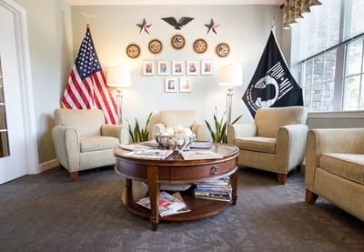 Cozy common area with flag displays and seating arrangement