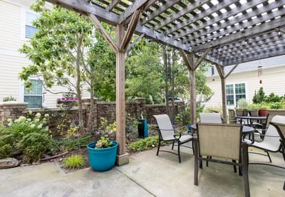 Outdoor patio area with seating and greenery