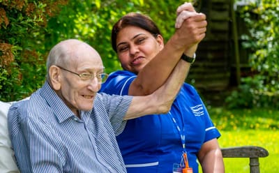 A resident and staff member enjoying the outdoors