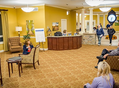 Residents and staff interacting in a lobby area