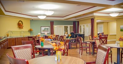 Interior dining room with residents and autumn decorations