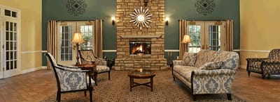 Cozy interior common area with a fireplace and seating