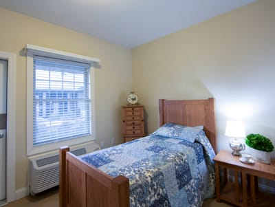 Cozy private resident room with a bed and window