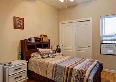 Cozy resident room with a bed and personal items