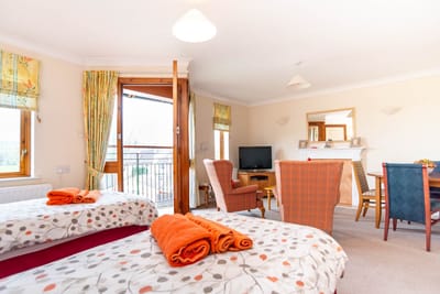 Cozy interior view of a resident room with seating and decor
