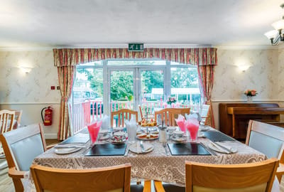Dining room set for a meal with outdoor view