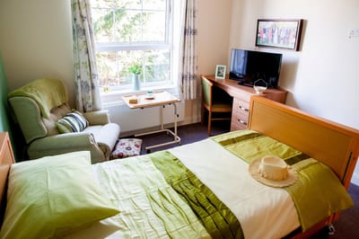 Cozy resident room with bed and seating area