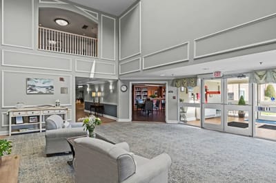 Bright interior common area with seating and bookshelves