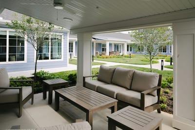 Outdoor seating area with sofas and greenery