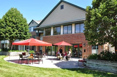 Residents enjoying time outside under umbrellas