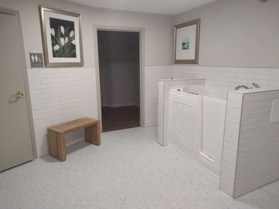 Interior view of a stylish bathroom with a bench and tub