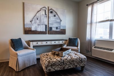Cozy sitting area with artwork and comfortable chairs