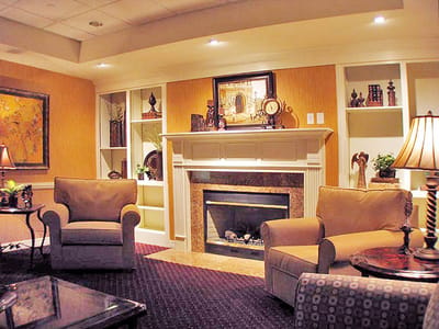 Cozy common area with armchairs and a fireplace