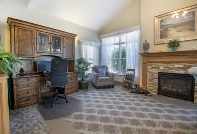 Comfortable lounge area with a desk and fireplace