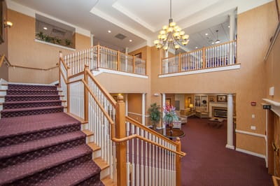 Interior view of a welcoming lobby with staircase