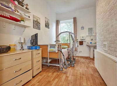 Private resident room with medical equipment and furniture