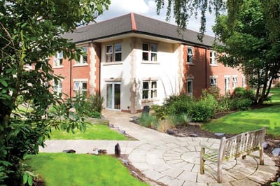 Exterior view of the nursing home building with garden