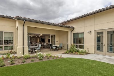 Patio area with seating and garden in a senior living community
