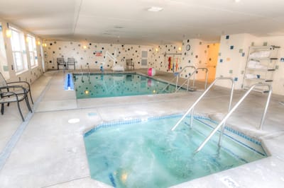 Indoor pool area with an adjoining hot tub