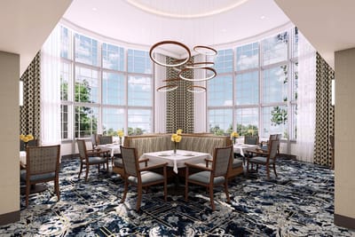 Bright dining room with large windows and floral centerpieces