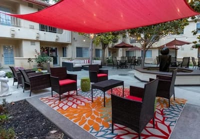 Outdoor seating area with umbrellas and garden decor